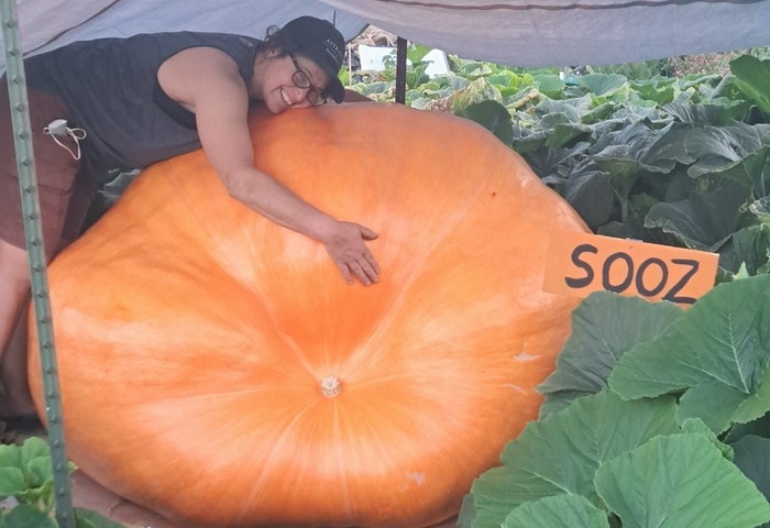 a picture of Gorge forecaster Temira with a giant pumpkin that they grew